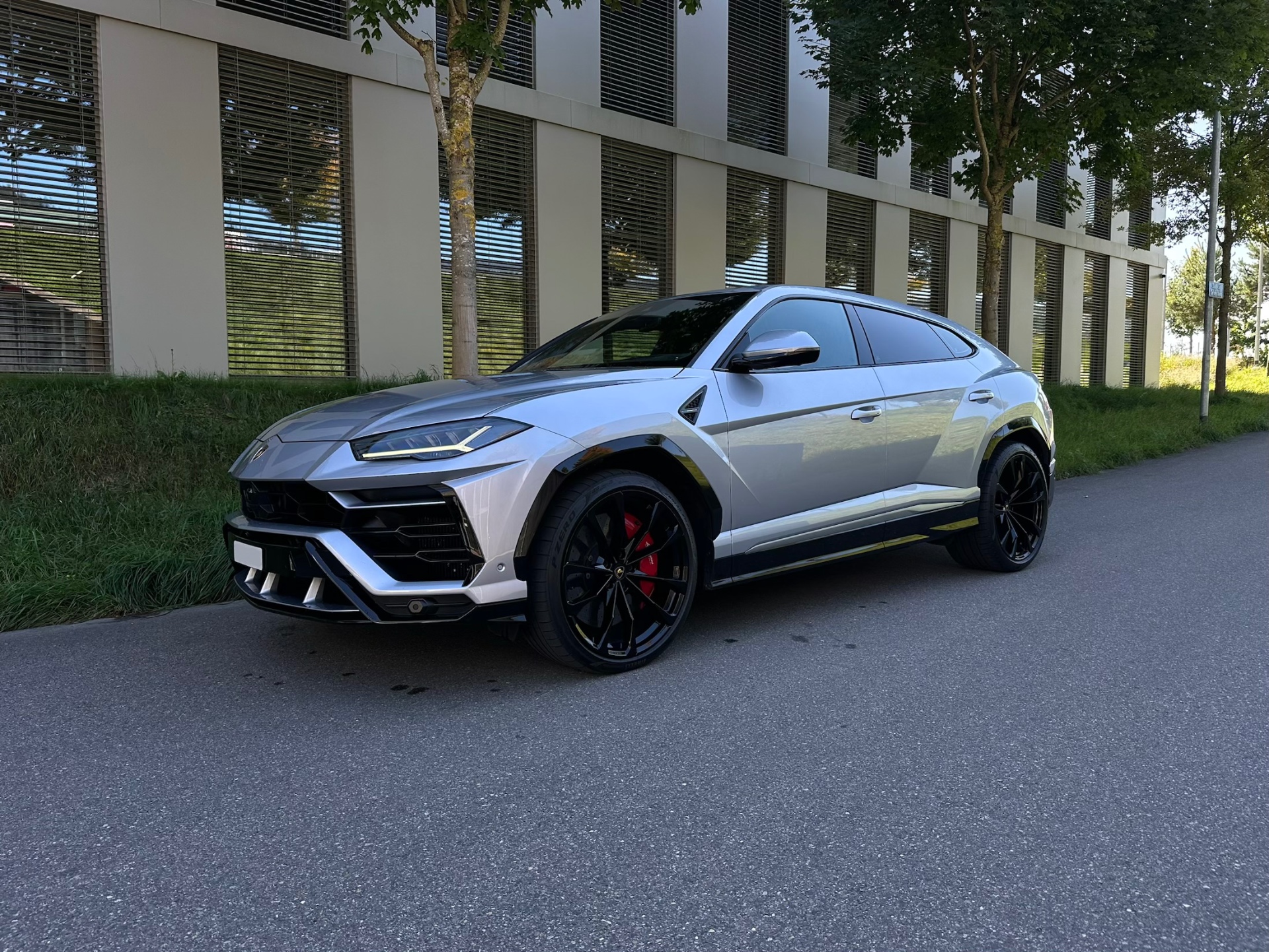 Phone snap of a car next to its showroom render — before