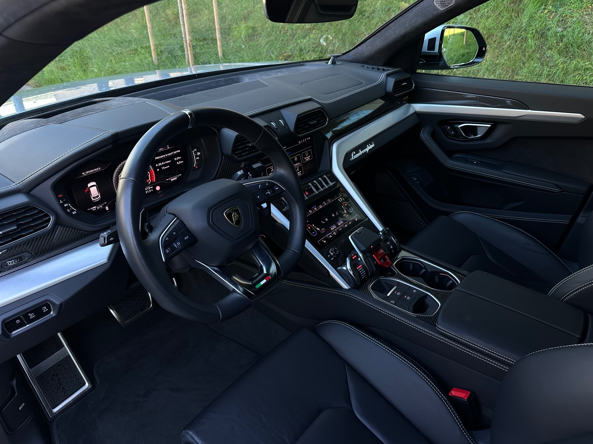 Phone snap of a car interior next to its showroom render — before